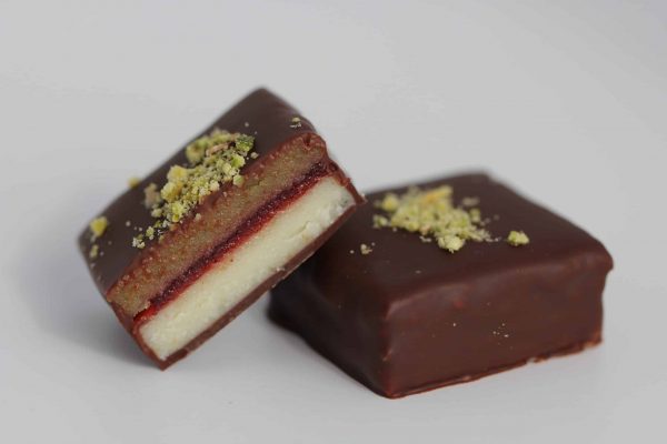 Layers of strawberry jelly, pistachio paste and white chocolate.